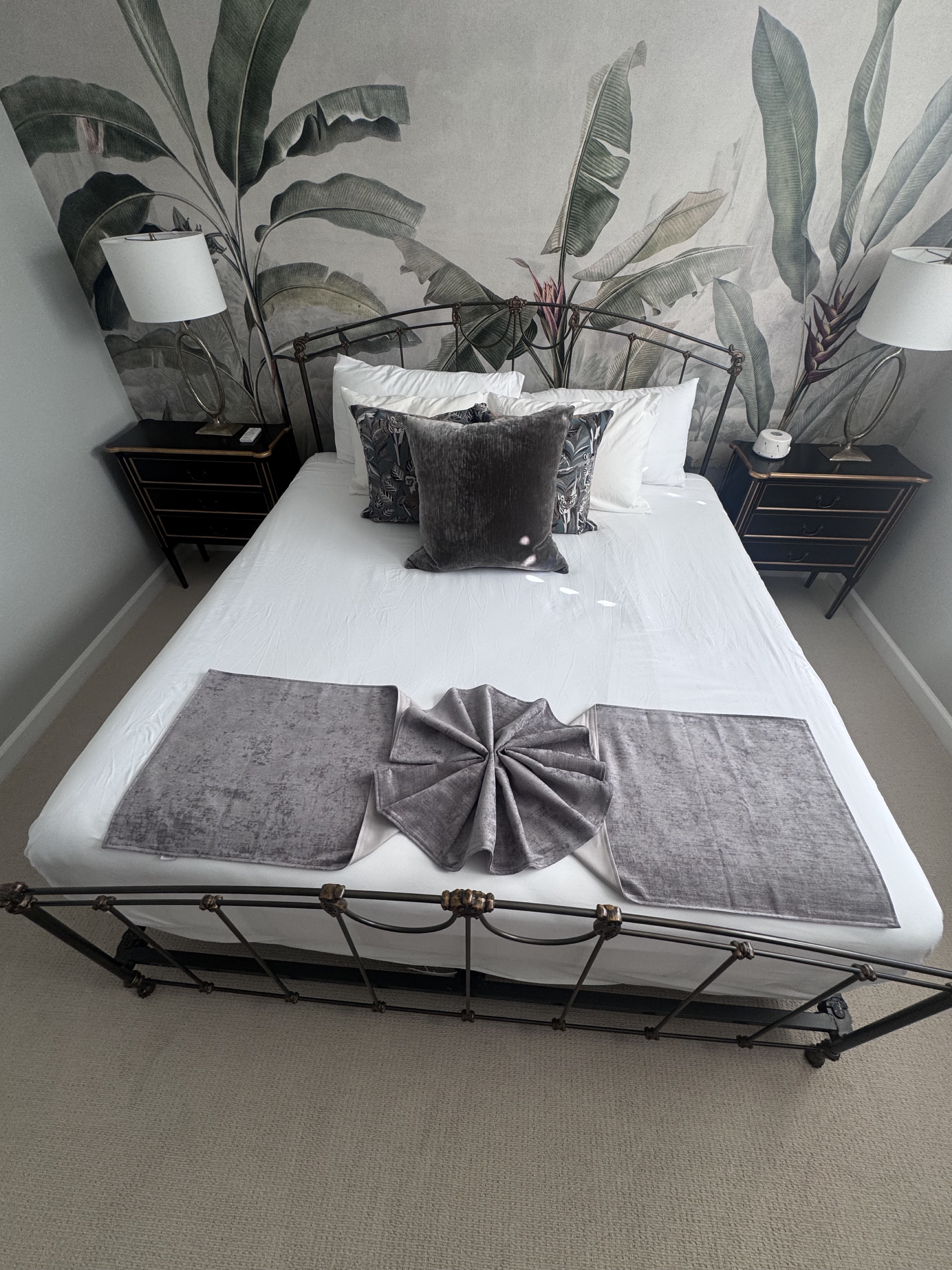 Bed made with folded towels and styled pillows